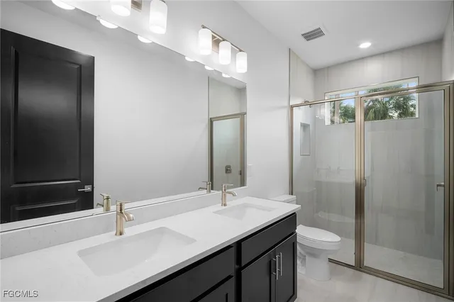 a bathroom with a sink shower and a mirror