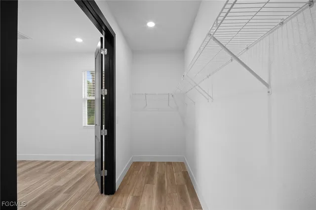 a view of hallway with wooden floor