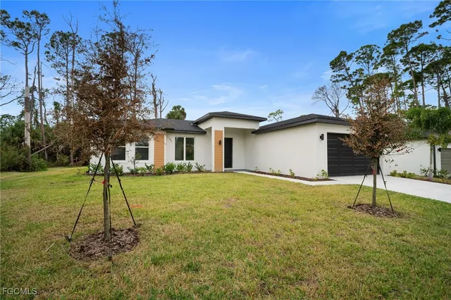 a house with a yard and a large tree