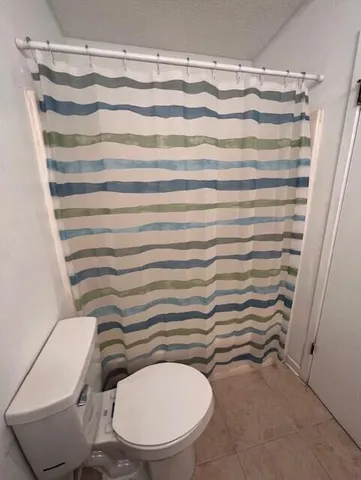 a bathroom with a sink vanity mirror and toilet