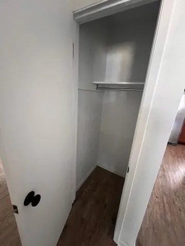 a view of a room with wooden floor and carpet