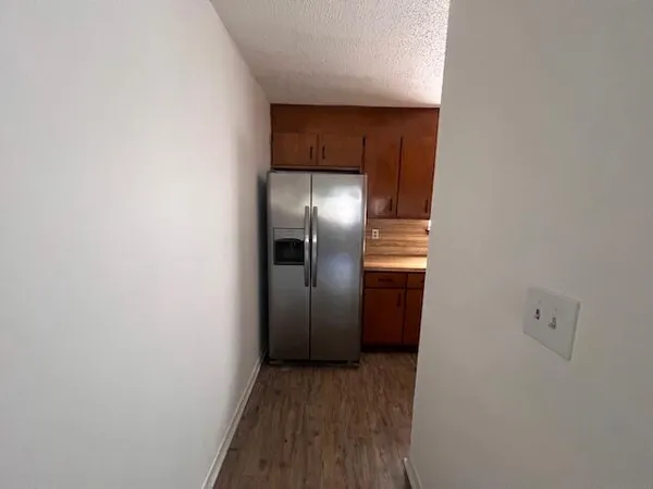 a view of hallway with wooden floor