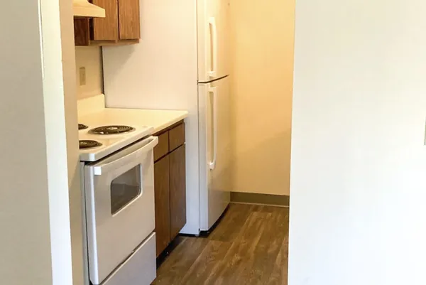 a kitchen with a stove and a refrigerator