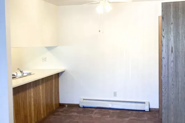 a room with a white wall and a window