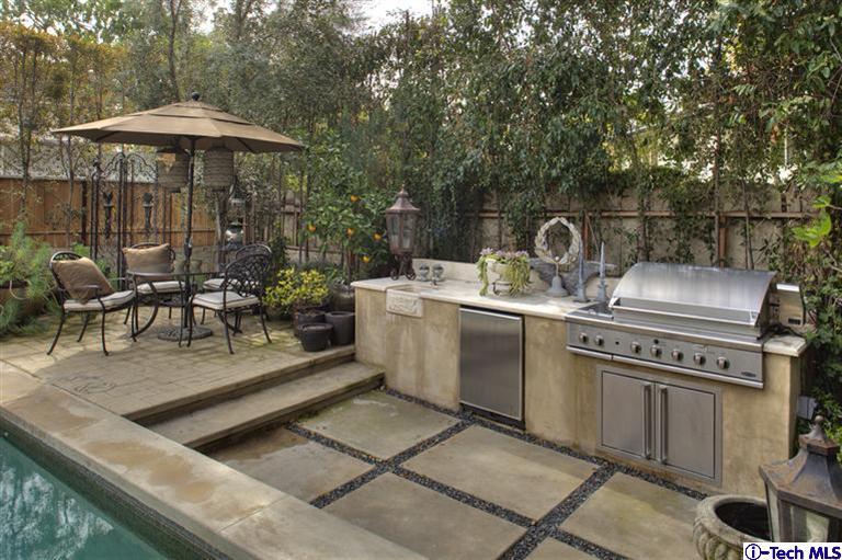 Undisclosed Address San Marino, CA 91108 - Photo 4 of 58 a terrace with a table and chairs under an umbrella