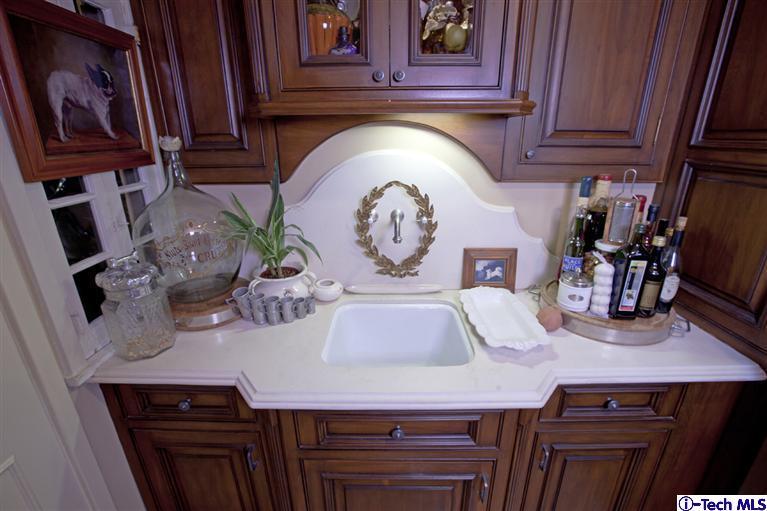 Undisclosed Address San Marino, CA 91108 - Photo 35 of 58 a room with kitchen island a stove and a refrigerator with wooden floor