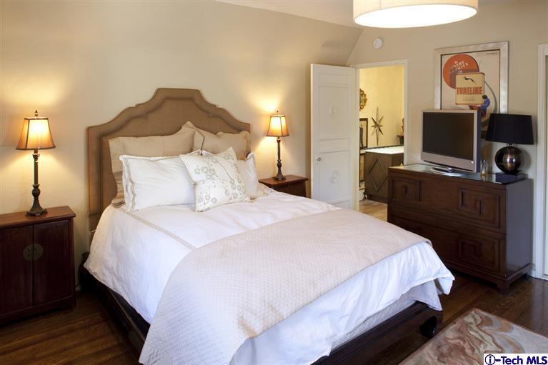 Undisclosed Address San Marino, CA 91108 - Photo 45 of 58 a bedroom with a bed and a flat tv screen on dresser