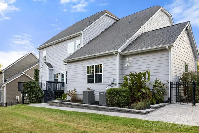 a house that has a swimming pool in front of it