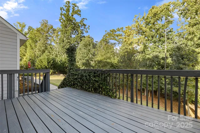 a balcony with wooden floor and city view