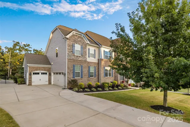 a front view of a residential apartment building with a yard