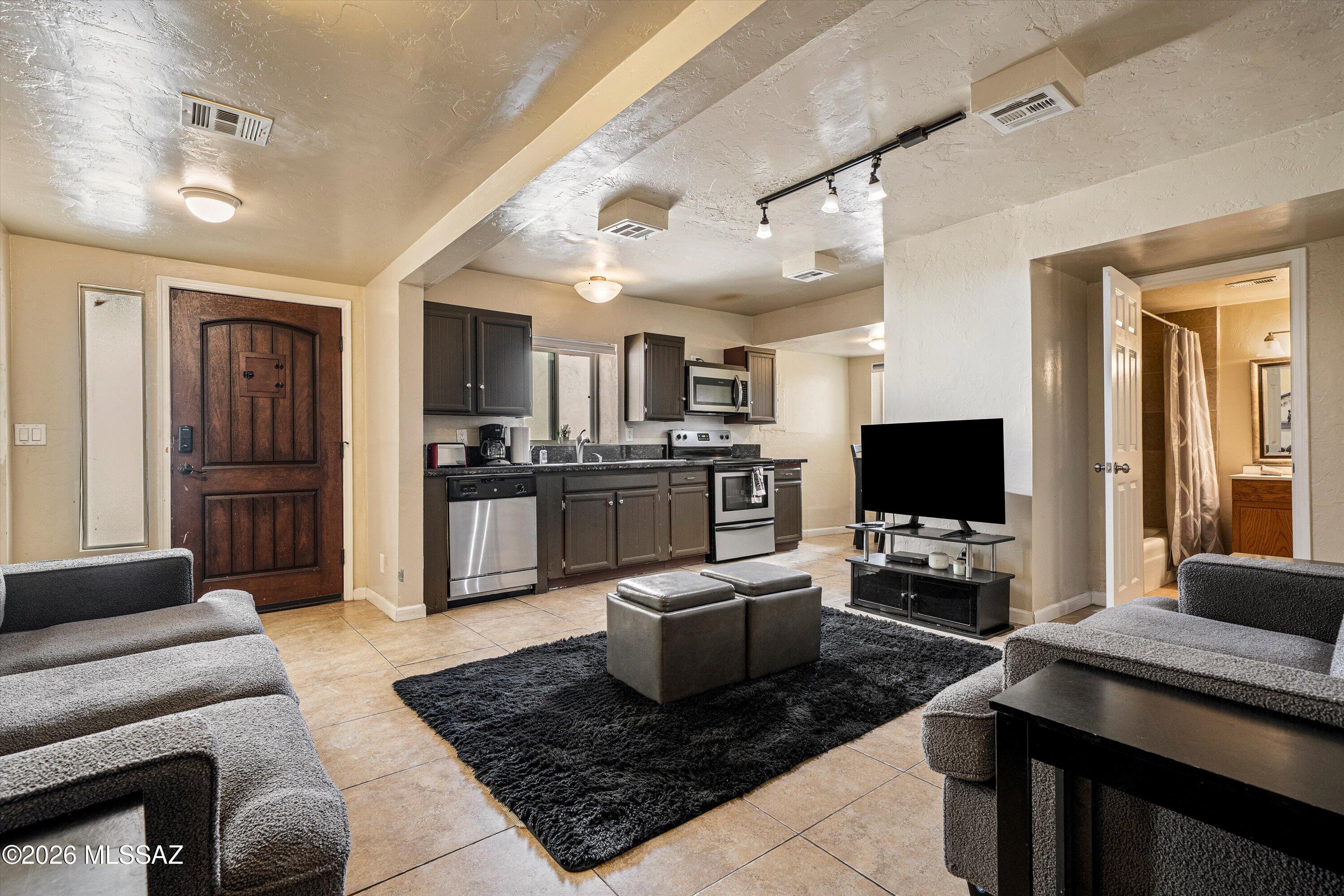 2619 East Prince Road Tucson, AZ 85716 - Photo 41 of 50 a living room with furniture and a flat screen tv