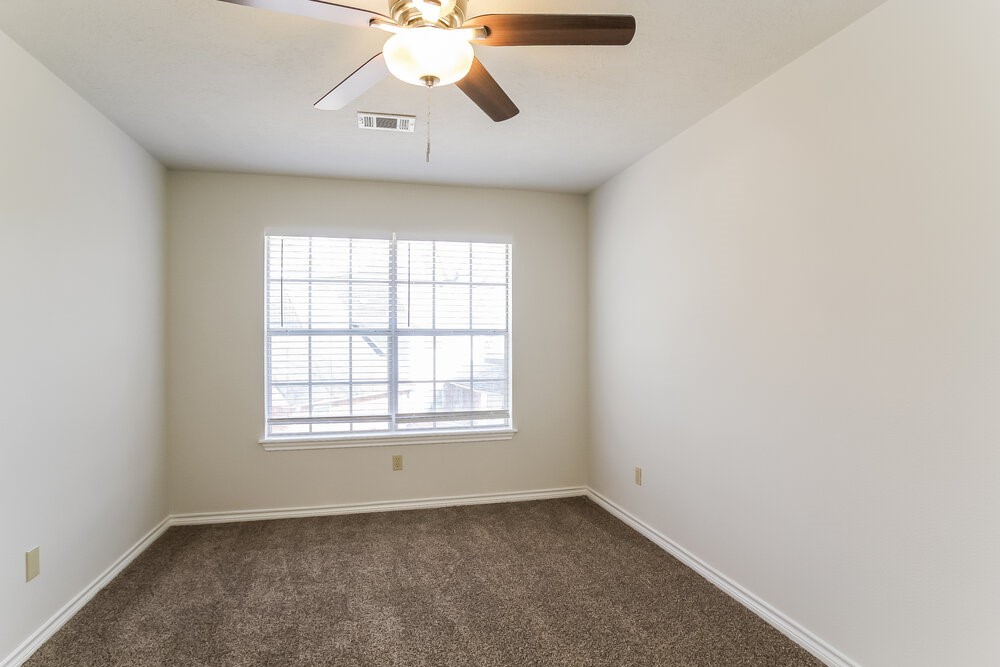 3407 El James Drive Spring, TX 77388 - Photo 14 of 17 an empty room with chandelier fan and windows