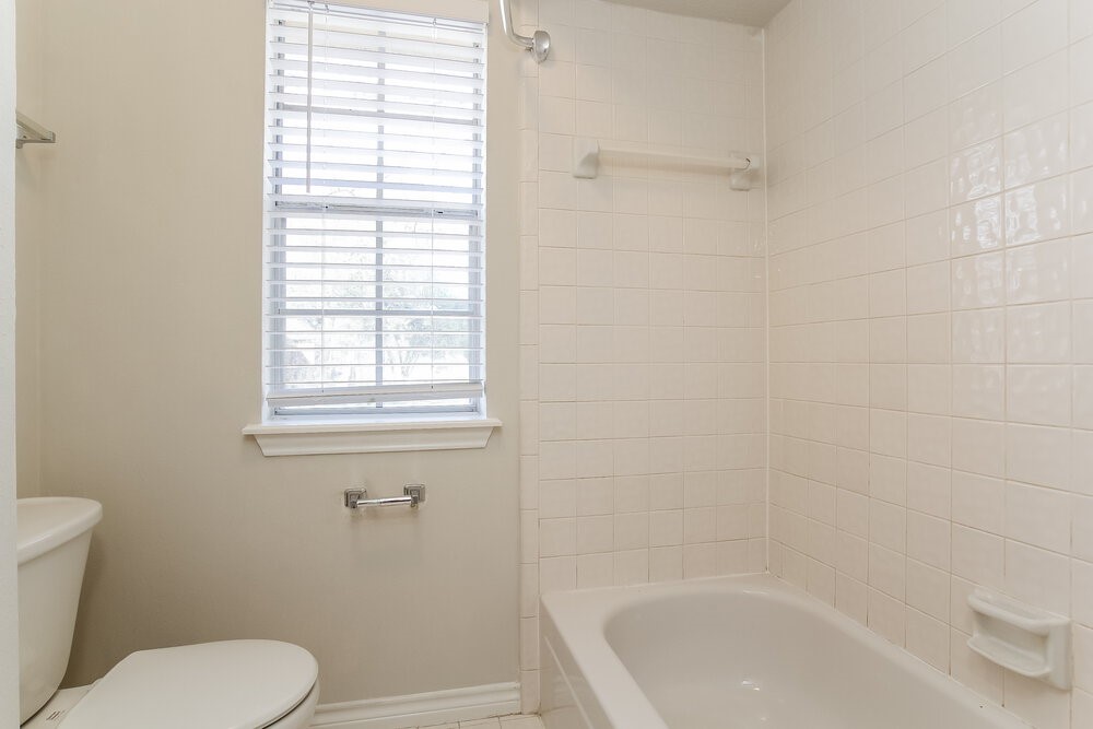3407 El James Drive Spring, TX 77388 - Photo 16 of 17 a white toilet sitting next to a bath tub