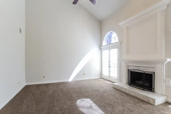a view of empty room with fireplace and window