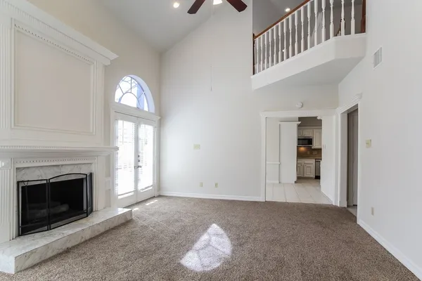 a view of a livingroom with an empty space and a fireplace