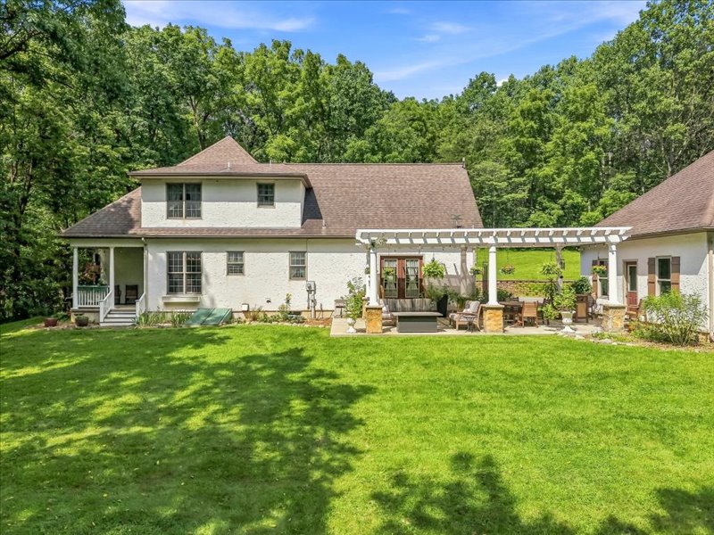 1168 Mt Pleasant Road Bangor, PA 18013 - Photo 19 of 100 A spacious green lawn sits behind this two-story home featuring a detailed white pergola.