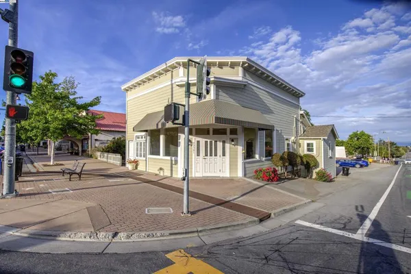 a front view of a house with sitting area