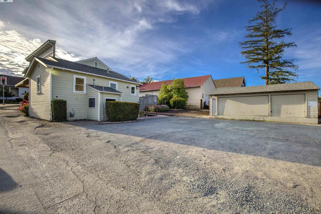 43301 Mission Boulevard Fremont, CA 94539 - Photo 2 of 30 a front view of a house with a yard and garage