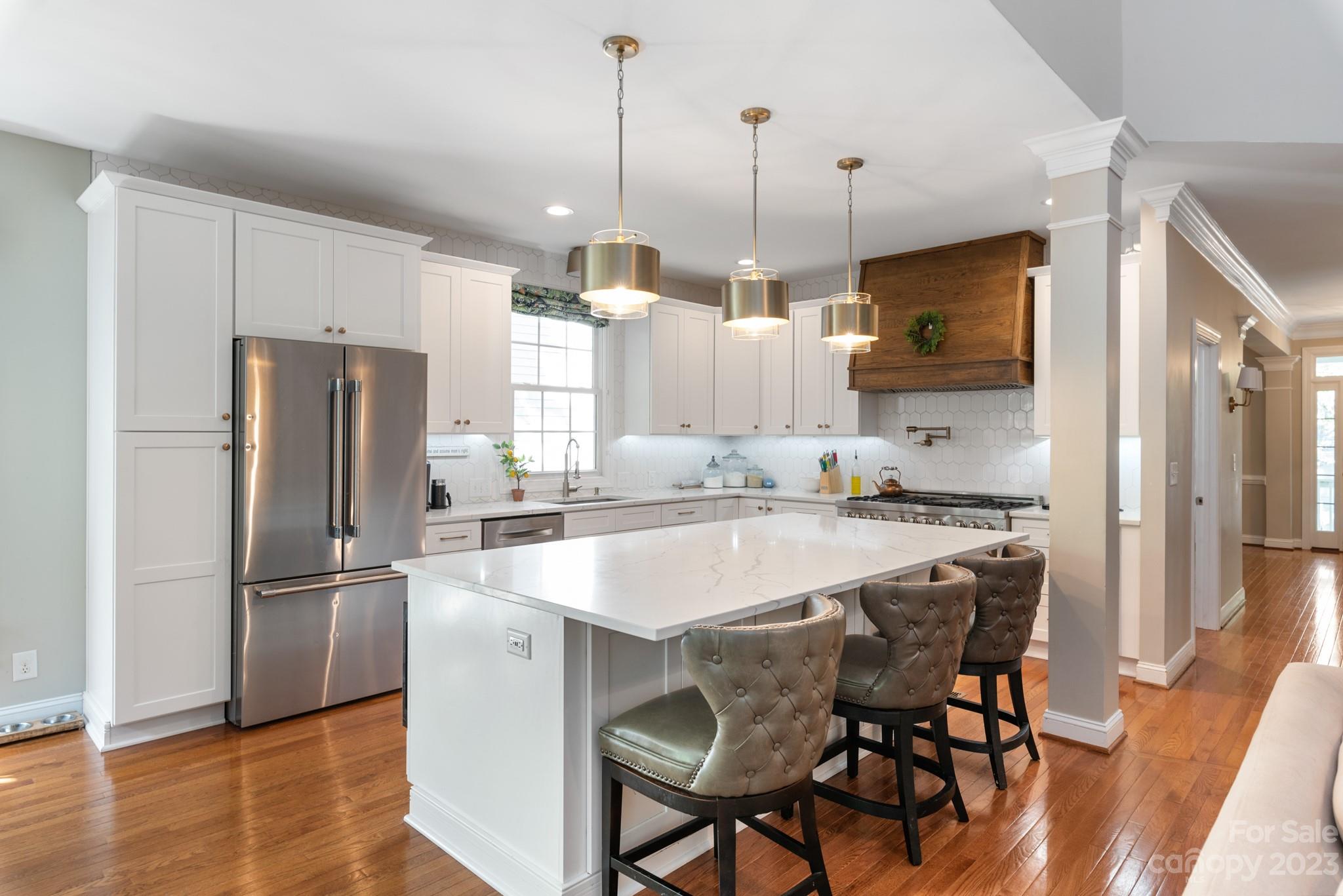 911 Stratford Run Drive Fort Mill, SC 29708 - Photo 17 of 45 a kitchen with kitchen island a refrigerator a stove a sink and a chairs