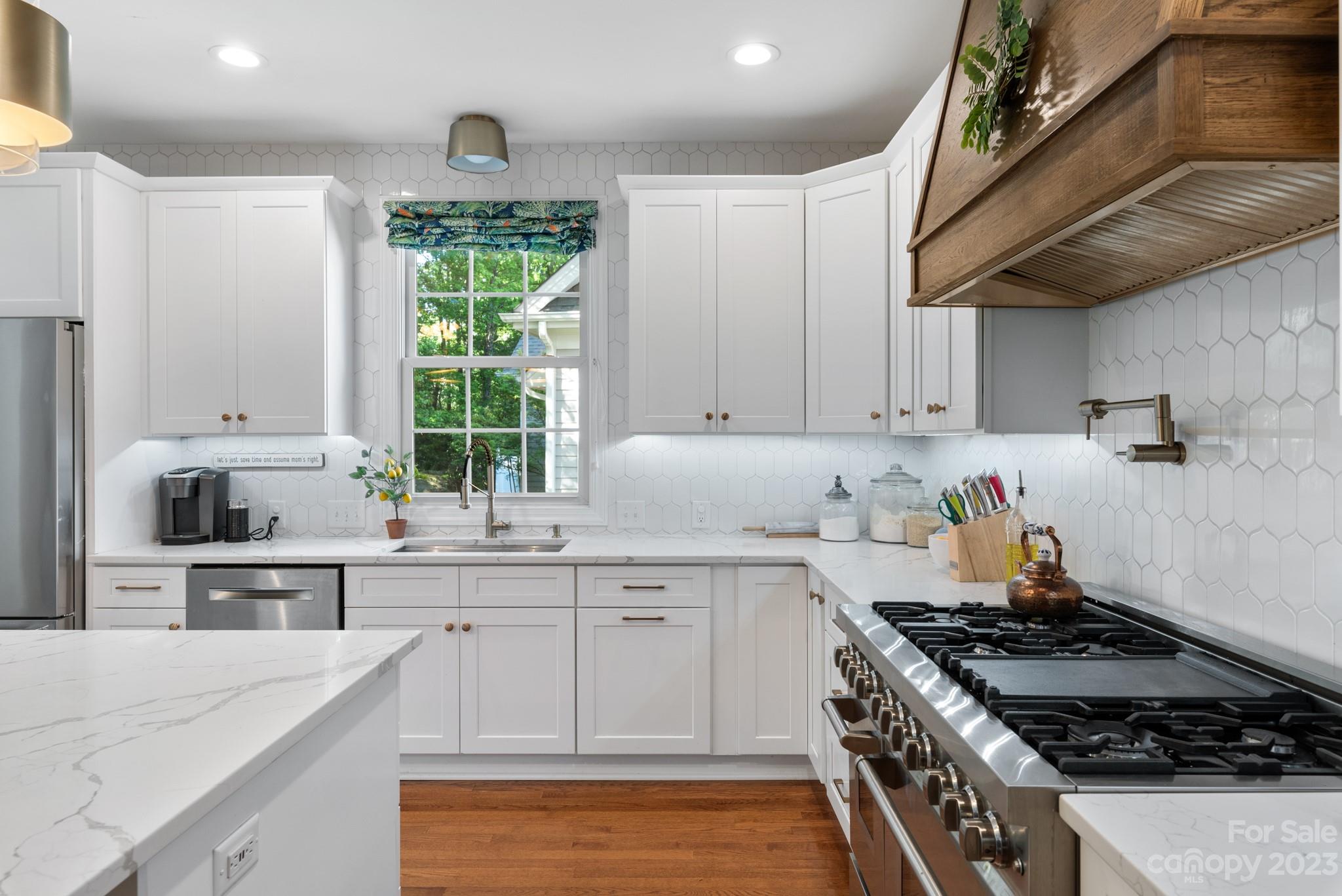 911 Stratford Run Drive Fort Mill, SC 29708 - Photo 18 of 45 a kitchen with stainless steel appliances a sink a stove and cabinets