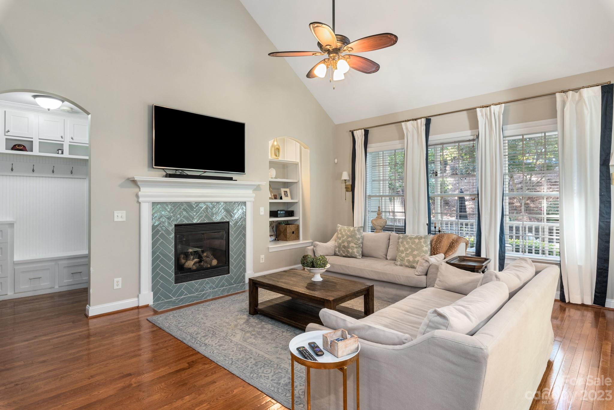911 Stratford Run Drive Fort Mill, SC 29708 - Photo 24 of 45 a living room with furniture a flat screen tv and a fireplace