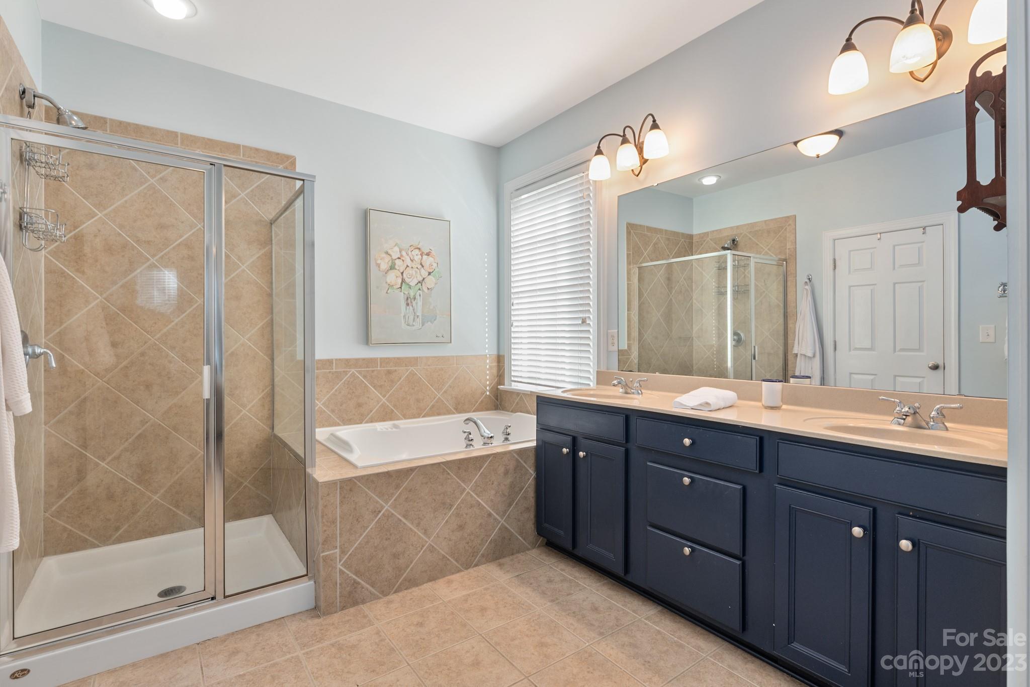911 Stratford Run Drive Fort Mill, SC 29708 - Photo 34 of 45 a spacious bathroom with a bathtub shower sink mirror and