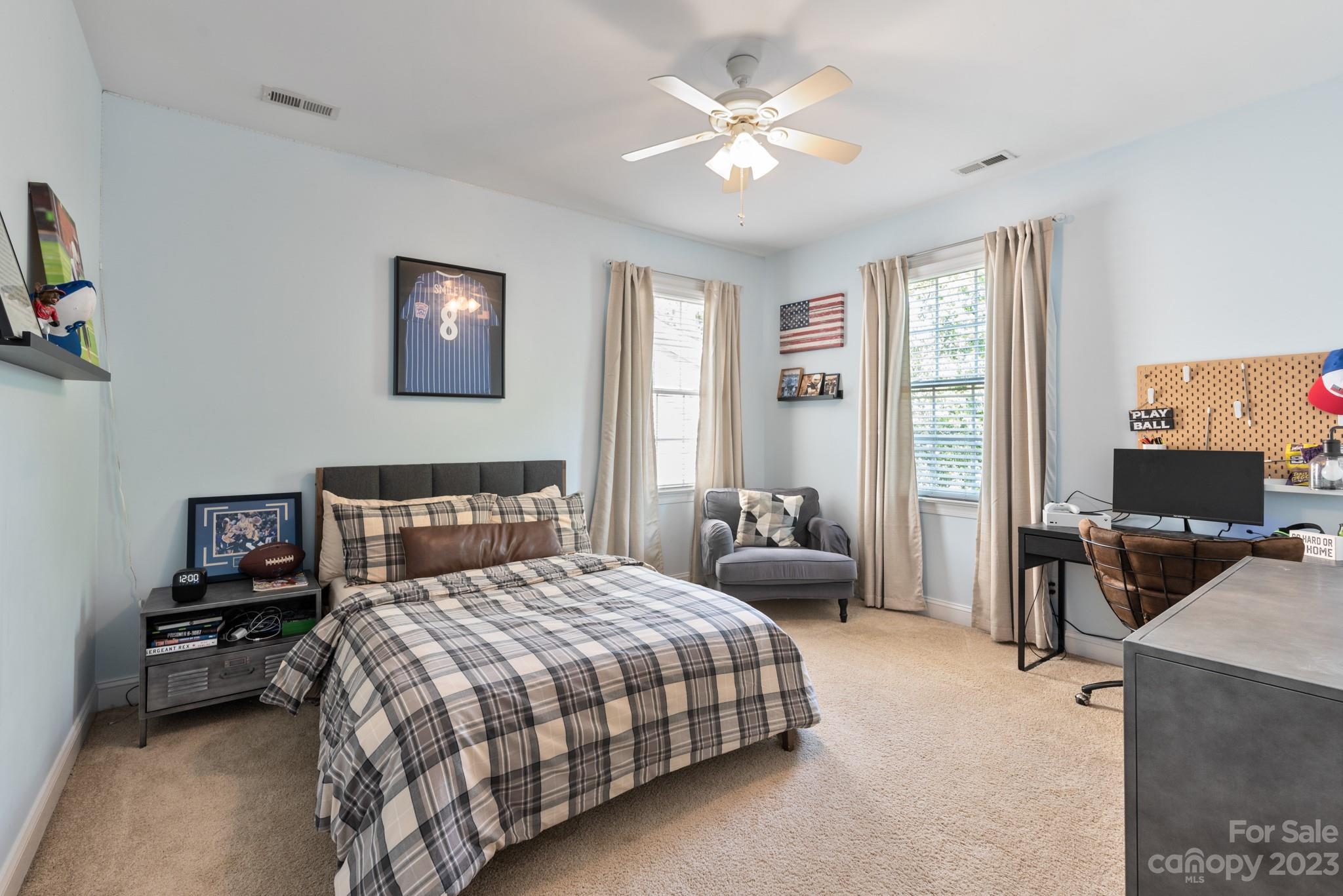 911 Stratford Run Drive Fort Mill, SC 29708 - Photo 38 of 45 a bedroom with a bed and a chandelier