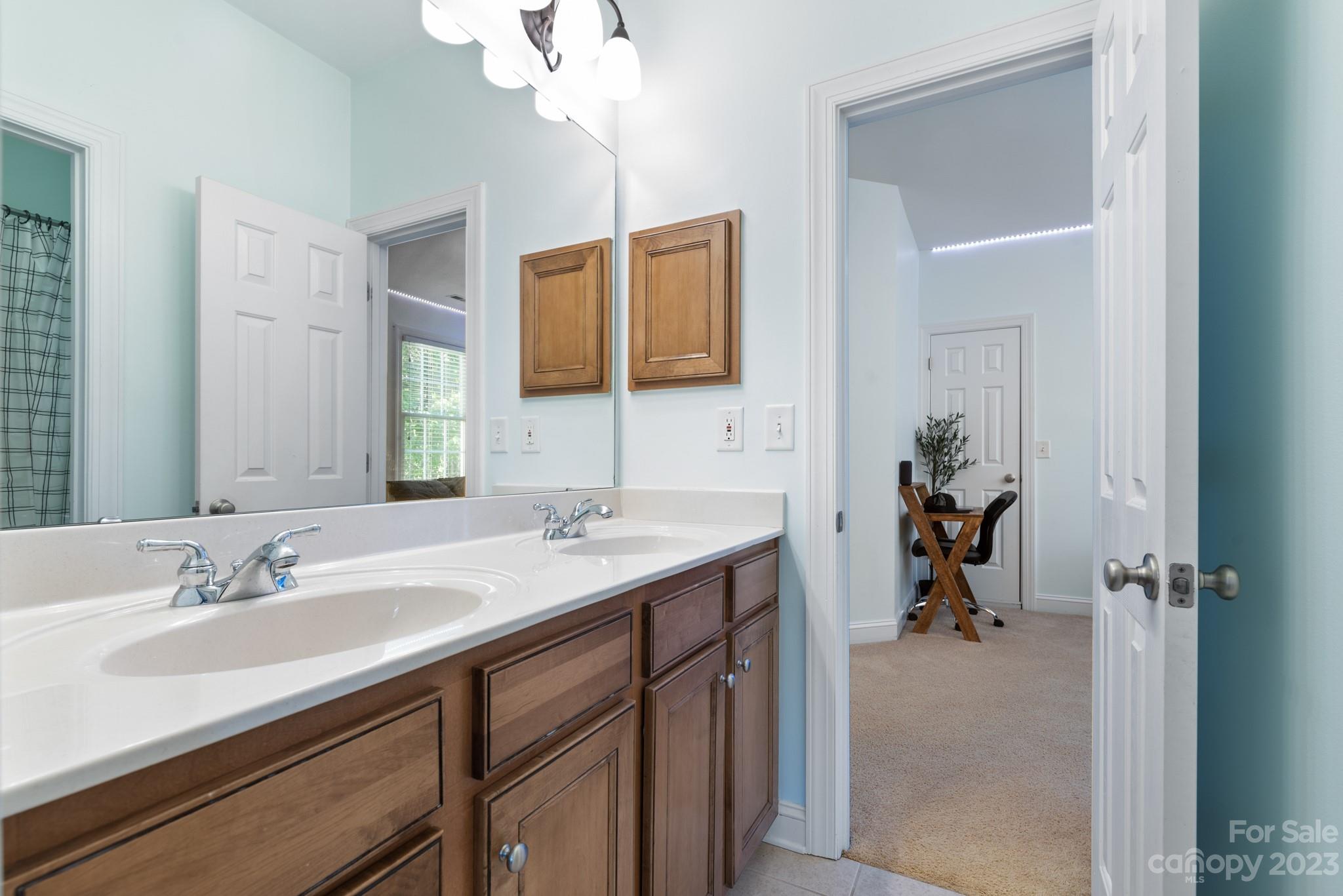 911 Stratford Run Drive Fort Mill, SC 29708 - Photo 39 of 45 a bathroom with a sink double vanity granite and a mirror