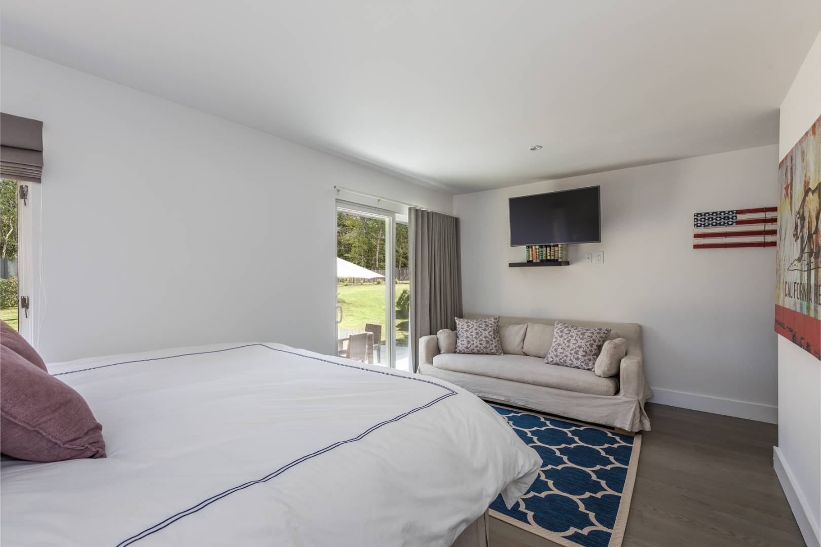 81 Neck Path East Hampton, NY 11937 - Photo 17 of 24 a bedroom with a bed and a couch