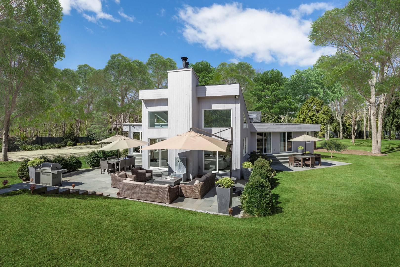 81 Neck Path East Hampton, NY 11937 - Photo 4 of 24 a front view of a house with garden and sitting area