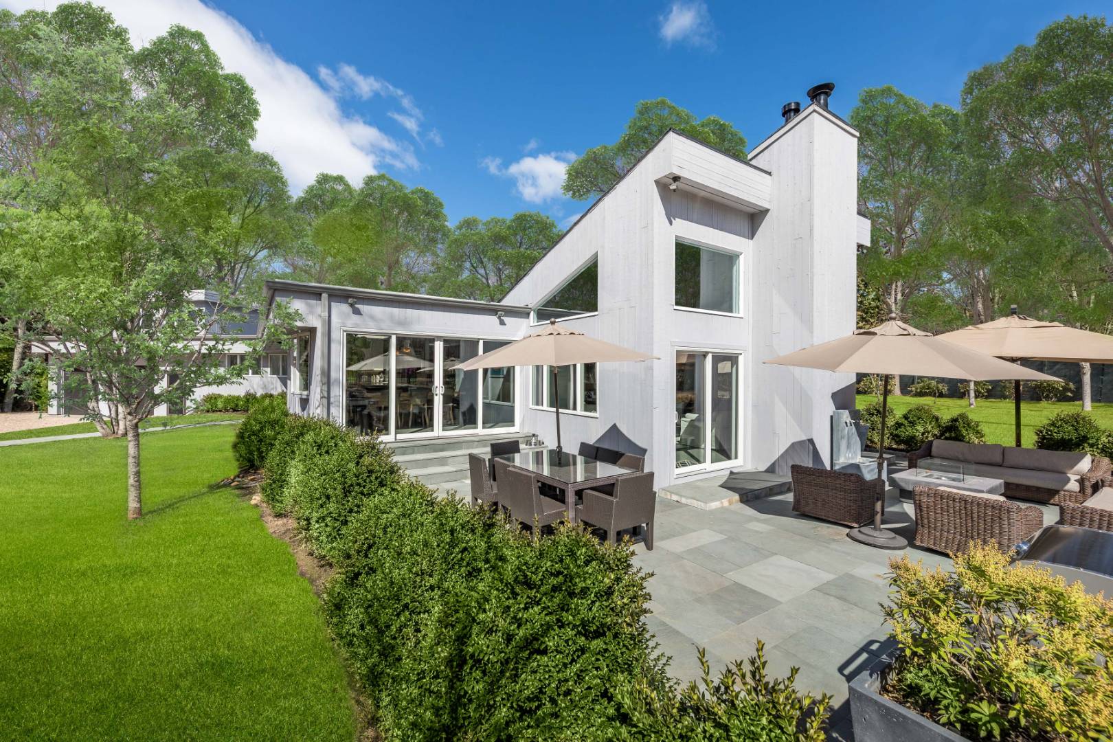 81 Neck Path East Hampton, NY 11937 - Photo 5 of 24 a view of a house with backyard sitting area and garden