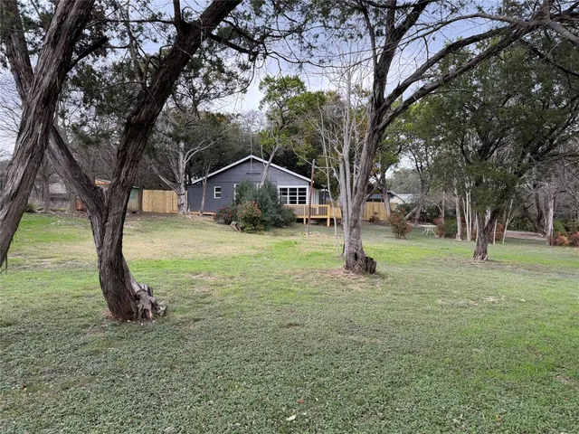 a white house in middle of the forest