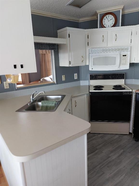 12531 Southeast 140th Avenue, Unit 118 Okeechobee, FL 34974 - Photo 15 of 26 a kitchen with stainless steel appliances granite countertop a sink a stove and a refrigerator