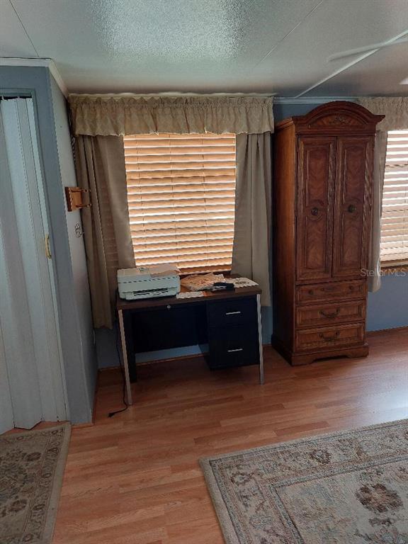 12531 Southeast 140th Avenue, Unit 118 Okeechobee, FL 34974 - Photo 17 of 26 a room with furniture and a dresser