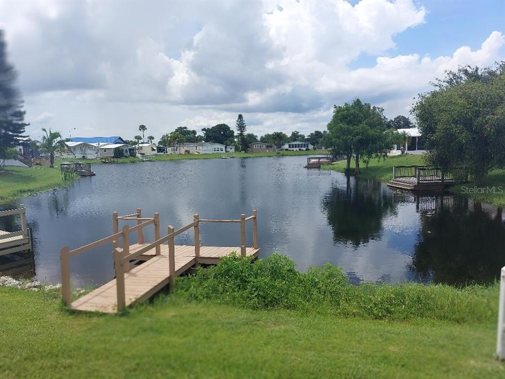 12531 Southeast 140th Avenue, Unit 118 Okeechobee, FL 34974 - Photo 2 of 26 a view of a lake with couches in the back yard