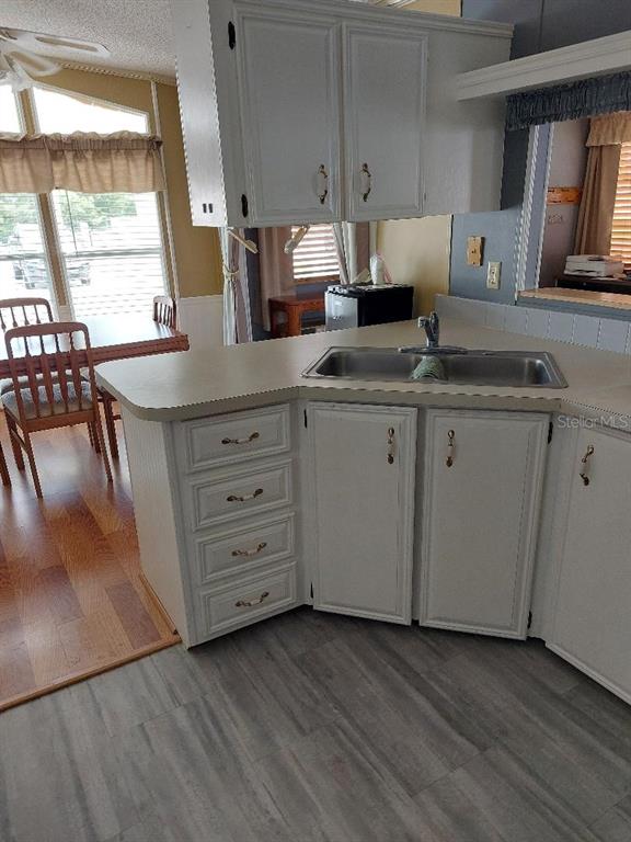 12531 Southeast 140th Avenue, Unit 118 Okeechobee, FL 34974 - Photo 9 of 26 a kitchen with granite countertop cabinets stainless steel appliances a sink and a window