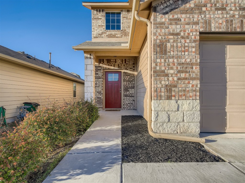 a view of a brick house with plants