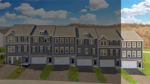 a front view of a residential apartment building with a yard