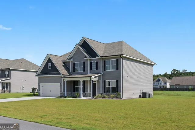 a front view of a house with a garden