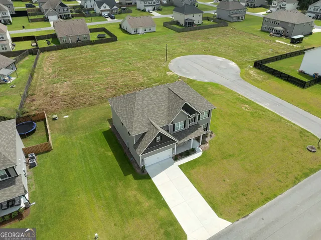 an aerial view of a house with swimming pool