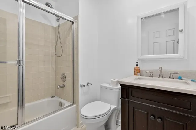 a bathroom with a sink vanity mirror and toilet