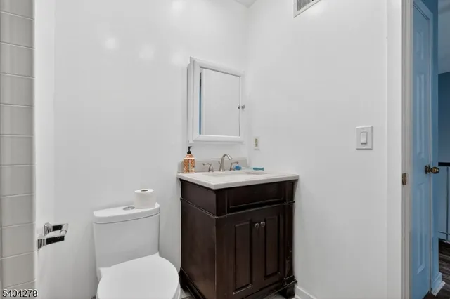 a bathroom with a sink toilet and a mirror