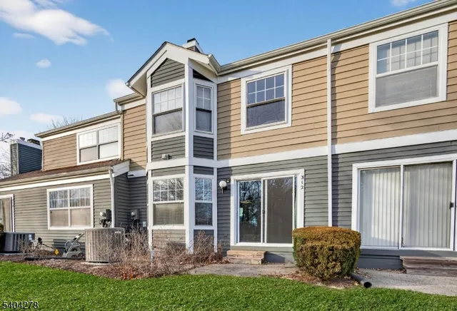 a front view of a house with a yard and outdoor seating