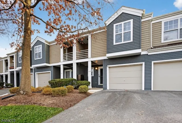 a view of a house with a yard and garage