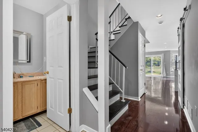 a view of a hallway with wooden floor and entryway