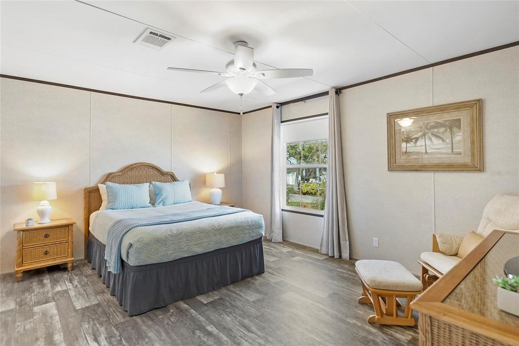 299 Puebla Road St. Augustine, FL 32080 - Photo 13 of 20 a spacious bedroom with a bed and a chandelier