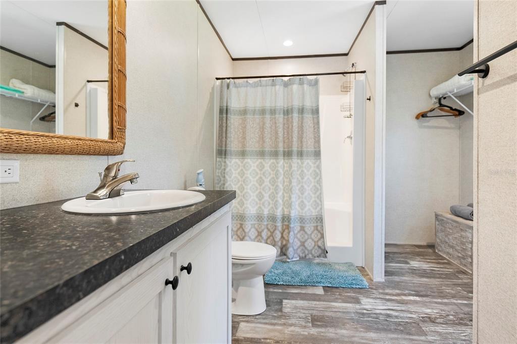 299 Puebla Road St. Augustine, FL 32080 - Photo 15 of 20 a bathroom with a granite countertop sink a toilet and a shower