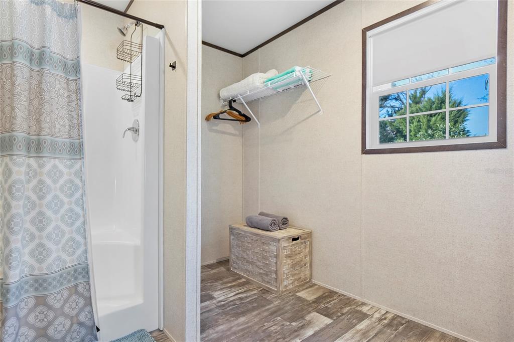 299 Puebla Road St. Augustine, FL 32080 - Photo 16 of 20 a bathroom with a window and a shower