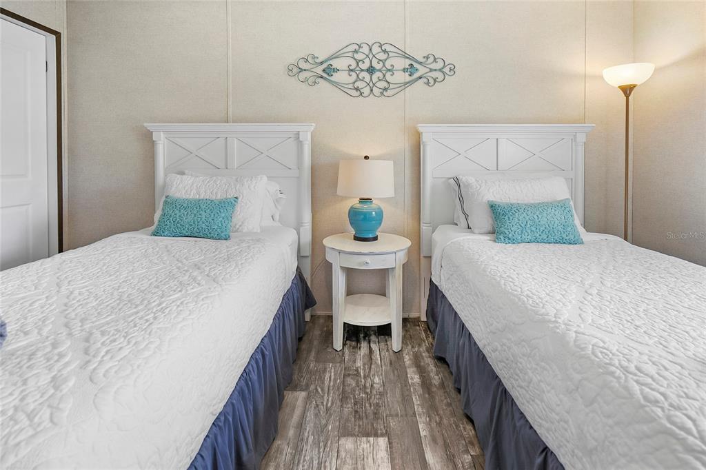 299 Puebla Road St. Augustine, FL 32080 - Photo 4 of 20 a bedroom with a bed and a chandelier