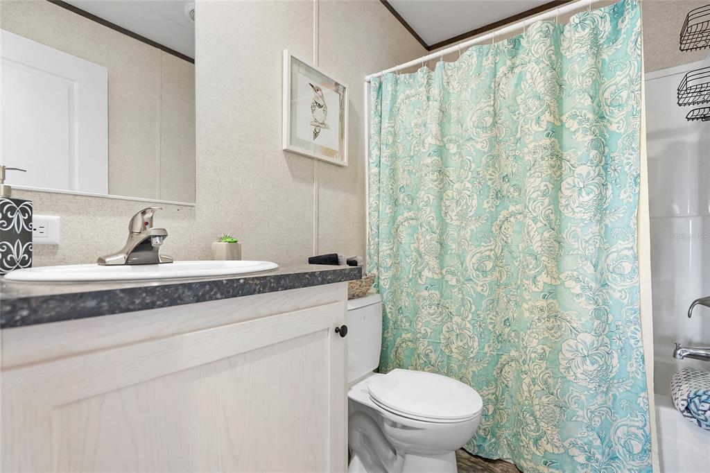 299 Puebla Road St. Augustine, FL 32080 - Photo 6 of 20 a bathroom with a granite countertop sink and a toilet